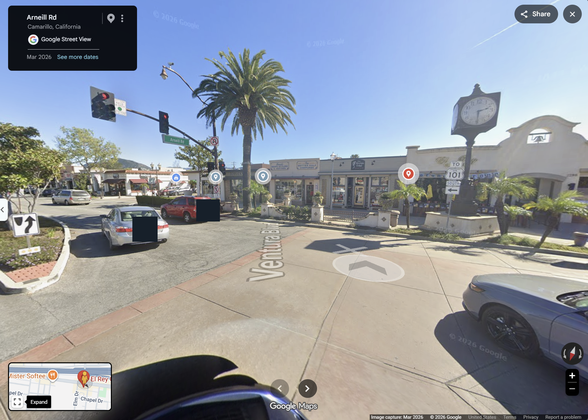 March 2026 Street View of Ventura Blvd at the Arneill Rd junction, with traffic signals, an Arneill Rd sign, the Old Town clock and the restaurant block.
